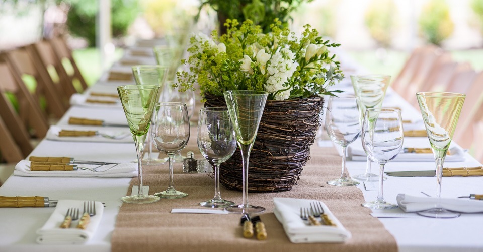 dining place setting with green wine glasses